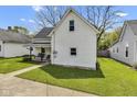 White two-story house with a swing on the front porch and green lawn at 223 Grove St, Greenfield, IN 46140
