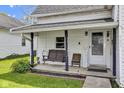 Inviting front porch with a swing, seating, and a 