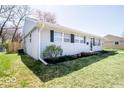 Landscaped front yard with healthy green grass around a light blue home at 2763 Streamside Dr, Columbus, IN 47203