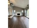 Living room featuring a fireplace, dark wood floors and sliding doors to a balcony at 2967 Eagles Crest Cir # C, Indianapolis, IN 46214