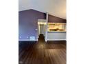 Open concept living room with dark wood floors leading to the kitchen and hallway at 2967 Eagles Crest Cir # C, Indianapolis, IN 46214