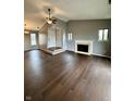 Open concept living room with fireplace, dark wood floors and neutral colored walls at 2967 Eagles Crest Cir # C, Indianapolis, IN 46214
