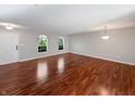 Spacious living room with hardwood floors and natural light streaming through arched windows at 3078 Armory Dr, Indianapolis, IN 46208