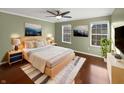 Cozy bedroom with a ceiling fan, plush rug, and art creating a relaxing space at 3078 Armory Dr, Indianapolis, IN 46208
