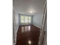 Well-lit bedroom featuring hardwood floors and three windows that bring in natural light at 317 Legacy Blvd, Greenwood, IN 46143
