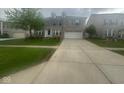 Residential house featuring mature landscaping and a spacious driveway at 317 Legacy Blvd, Greenwood, IN 46143