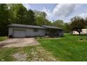 Cozy single-story home with a gray exterior, attached garage, and a well-maintained green lawn at 3282 S Conservation Club Rd, Morgantown, IN 46160