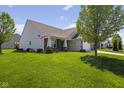 Well-maintained home with lush green lawn, mature tree, and inviting front porch at 3311 Stoddard Pl, Indianapolis, IN 46217