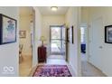 Bright foyer featuring a decorative rug, complemented by artwork and views into the dining area and beyond at 3480 Limelight Ln, Whitestown, IN 46075