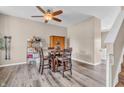 Cozy dining area featuring a wooden table, four chairs, and a modern ceiling fan at 401 Shadetree Ln, Sheridan, IN 46069