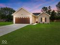 Charming single-story home featuring a well-manicured lawn and a two-car garage at 403 Fox Ridge Ct, Shelbyville, IN 46176