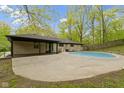 Spacious backyard featuring a swimming pool, patio area, and lush landscaping at 4475 Berkshire Rd, Indianapolis, IN 46226