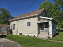 Home featuring a covered front porch, awning and well-maintained lawn at 5103 W Vermont St, Indianapolis, IN 46224