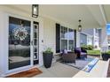Inviting front porch with cozy seating, stylish decor, and a welcoming entryway at 5580 Pintail Ln, Greenwood, IN 46143