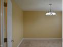 Neutral room featuring tan walls, carpeted floor and silver chandelier at 5708 Outer Bank Rd, Indianapolis, IN 46239