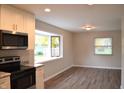Modern kitchen featuring stainless steel appliances and a bright eat-in nook with large windows at 5979 S Walcott St, Indianapolis, IN 46227