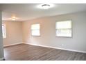 Bright living room featuring hardwood flooring and plenty of natural light from the windows at 5979 S Walcott St, Indianapolis, IN 46227