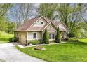 Attractive home featuring stone details, attached garage, and verdant landscaping at 6340 W 800 S, Pendleton, IN 46064