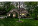 Beautiful home with stone accents, a well-kept lawn, and mature trees at twilight at 6340 W 800 S, Pendleton, IN 46064
