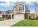 Charming two-story home with brick accents, a two-car garage, and a neatly landscaped front yard at 6540 Mccreery Ct, Indianapolis, IN 46221