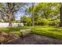 Green backyard with a cozy bench, perfect for relaxation and enjoying nature at 728 E Main St, Carmel, IN 46032