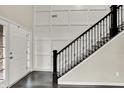 Elegant foyer featuring a staircase with iron railings and paneled wall at 769 Canberra Blvd, Westfield, IN 46074