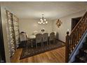 Elegant dining room showcasing wood floors, a large table with seating for six and decorative lighting at 7814 Crooked Meadows Dr, Indianapolis, IN 46268
