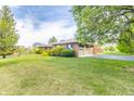 A sprawling lawn surrounds this house with a long driveway leading to an attached two-car garage at 8292 E 100 S, Greenfield, IN 46140