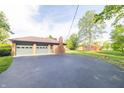 A paved driveway leads to a spacious two-car attached garage at 8292 E 100 S, Greenfield, IN 46140