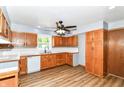 Bright kitchen featuring wood cabinets, white backsplash, and sleek countertops at 8308 W Main St, Coatesville, IN 46121