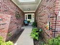 Welcoming entryway with brick walls, lovely decor, and ample natural light at 9653 Woodsong Way, Indianapolis, IN 46229