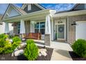 Charming front porch with a swing, manicured landscaping, and a welcoming entrance with wreath on the door at 9804 Canyon Ln, Pendleton, IN 46064