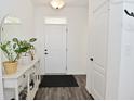 Bright entryway featuring neutral walls, wood-look flooring, a decorative table, and a front door at 9928 Deep Royal Way, Indianapolis, IN 46239