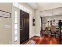 Welcoming foyer with hardwood floors, a decorative rug, and views into the dining room at 10882 Camden Ct, Fishers, IN 46038