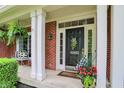 Covered front porch with white columns, decorative plants, and house number at 10882 Camden Ct, Fishers, IN 46038