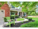 Inviting front yard with a walkway, garden beds, and an Adirondack chair at 10882 Camden Ct, Fishers, IN 46038