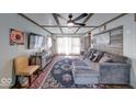 Cozy living room with decorative wood ceiling beams, stylish furniture and decor, and natural light from large windows at 109 N Avon Ave, Avon, IN 46123