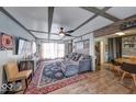 Warm living area featuring decorative ceiling beams, wood flooring, comfortable seating, and stylish accents at 109 N Avon Ave, Avon, IN 46123