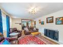 Cozy living room featuring a fireplace, plush leather seating, and decorative rug at 10935 Cornell St, Carmel, IN 46280