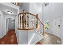 Bright foyer featuring a staircase with wood railing and a view to the outside at 11780 Pebblepointe Pass, Carmel, IN 46033