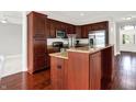 Well-equipped kitchen featuring dark wood cabinets, stainless steel appliances, and granite countertops at 127 Coatsville Dr, Westfield, IN 46074