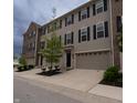 View of a townhome complex featuring garages, driveways and well-maintained landscaping at 14226 Frostburg Dr, Carmel, IN 46033