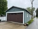 Spacious detached garage with dark brown door, matching the home's exterior siding at 1567 Logan St, Noblesville, IN 46060