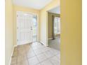 Inviting entryway features tile flooring, a white front door with glass, and neutral paint, creating a warm welcome at 1645 Woodview Ln, Anderson, IN 46011