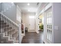 Bright foyer with hardwood floors, staircase with decorative railing, and elegant French doors to the workout room at 1648 Rossmay Dr, Westfield, IN 46074