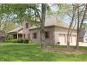 Three car garage on a well maintained house with manicured lawn and professional landscaping at 17003 Whitebark Ct, Westfield, IN 46074