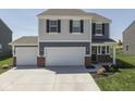 Beautiful home with a two-car garage and well-manicured lawn at 192 Bluestem Ln, Whiteland, IN 46184