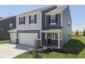 Charming two-story home with a two-car garage and lovely landscaping at 192 Bluestem Ln, Whiteland, IN 46184