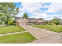 Exterior view of home featuring an attached garage and well-kept lawn at 1934 Constitution St, Greenfield, IN 46140