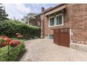 Tranquil backyard featuring a brick patio, vibrant hanging baskets, and lush greenery at 196 E Madison St, Franklin, IN 46131
